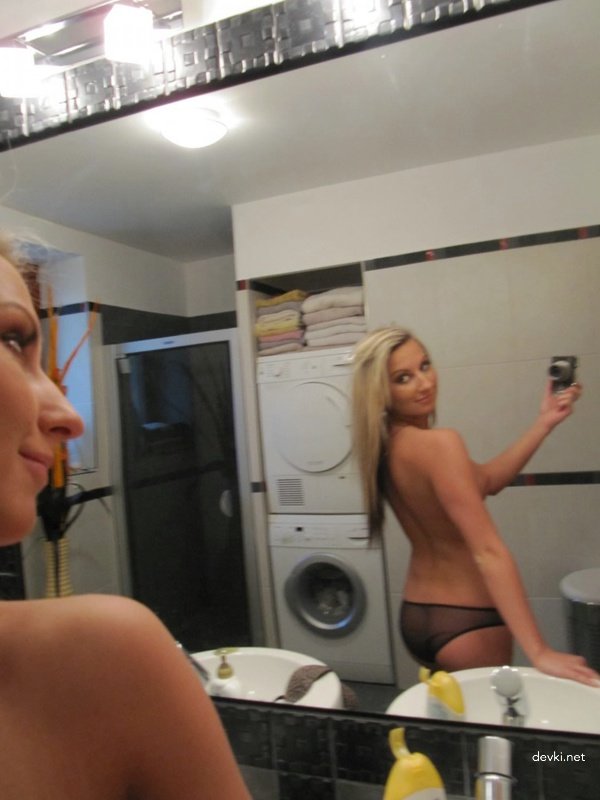 Young amateur strips naked in front of the mirror