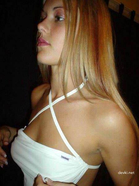 Seductive Blonde in Fitting Room: Amateur Photo with Explicit Appeal