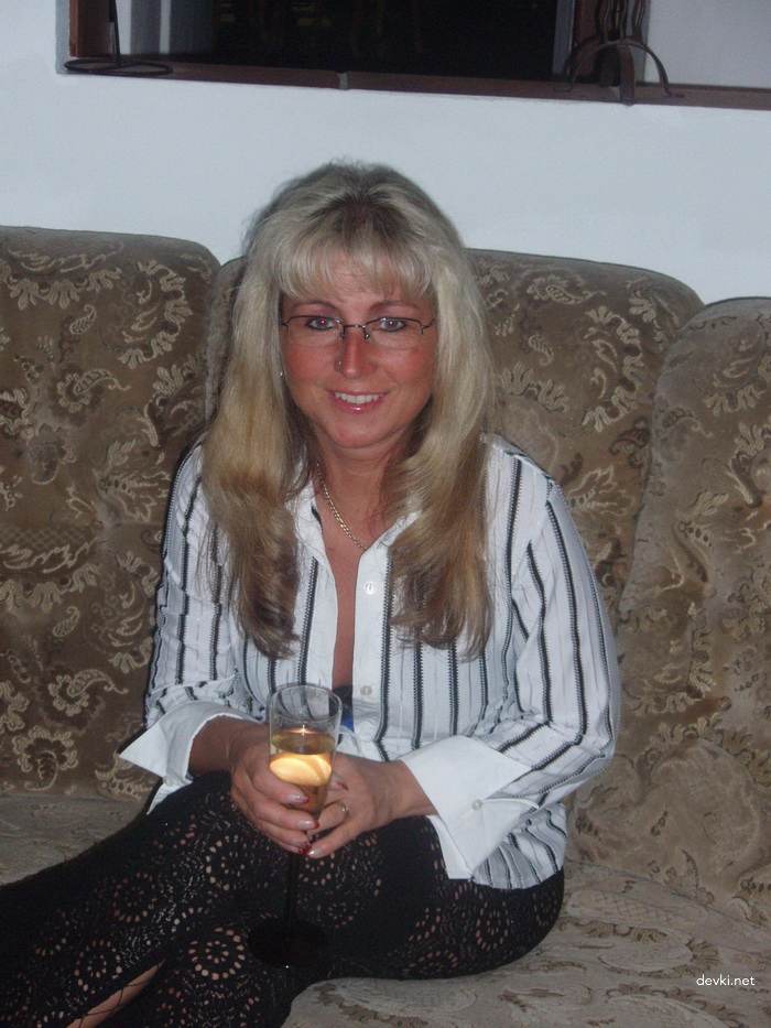 Mature MILF strips and sucks cock - explicit blowjob photo
