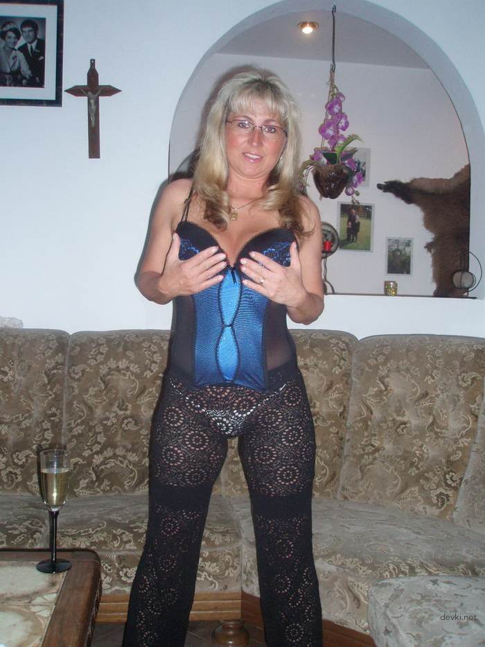 Mature MILF strips and sucks cock - explicit blowjob photo