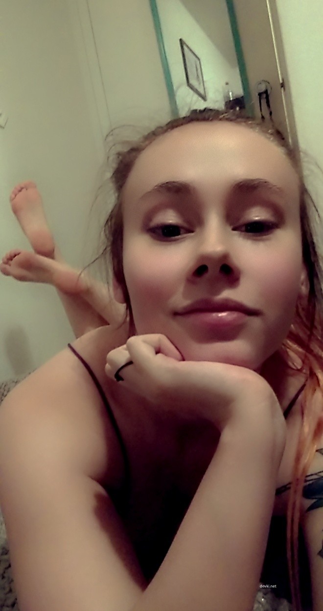 Voluptuous Smile: Busty Amateur Beauty Exposing Assets in Provocative Pose