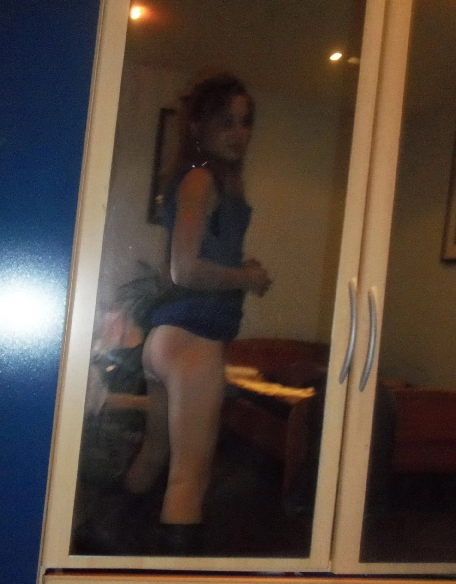 Girl strips off pantyhose and panties in front of guy - Explicit amateur porn photo.